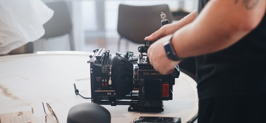 A man holding two cameras, one in each hand.